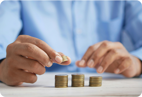 Person in business shirt stacking coins representing budget planning and condo association fee management for community finances